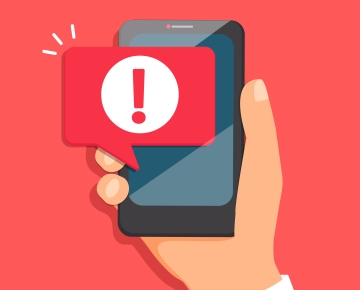 Alert icon on mobile phone. 