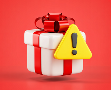 gift in white box with red bow and red background next to yellow exclamation point