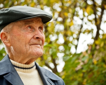 elderly man in hat looking off into the distance