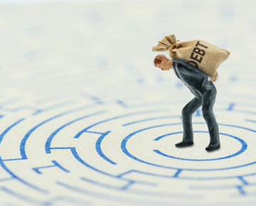 small action figure holding bag that says debt with maze on the ground