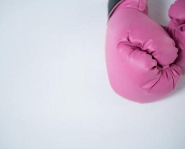 Pink boxing gloves gray background
