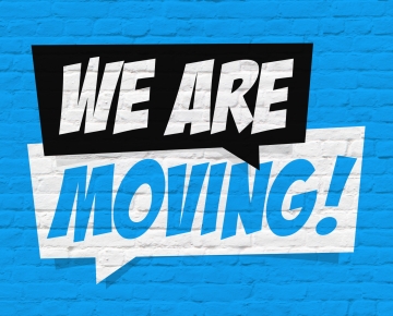 we are moving text in white, black, and blue against blue brick background