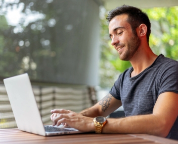 Gentleman checking statements online using a laptop