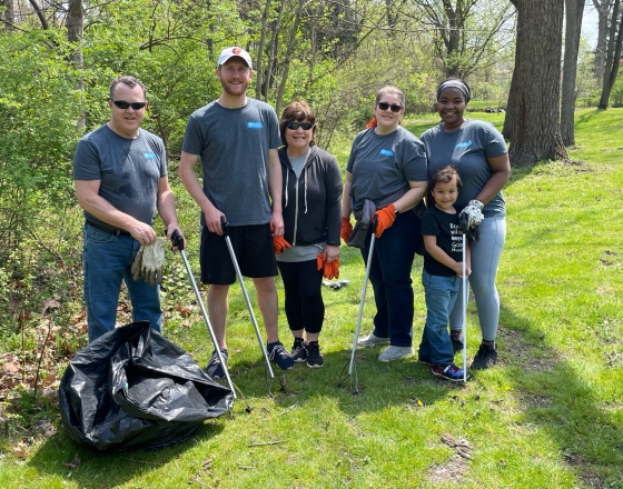 group cleaning up surrounded by grass