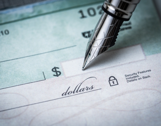 Pen writing on check. 