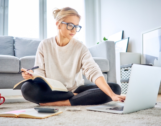 Woman Sitting On Floor Using Computer