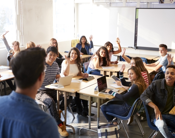 man teaching students in classroom