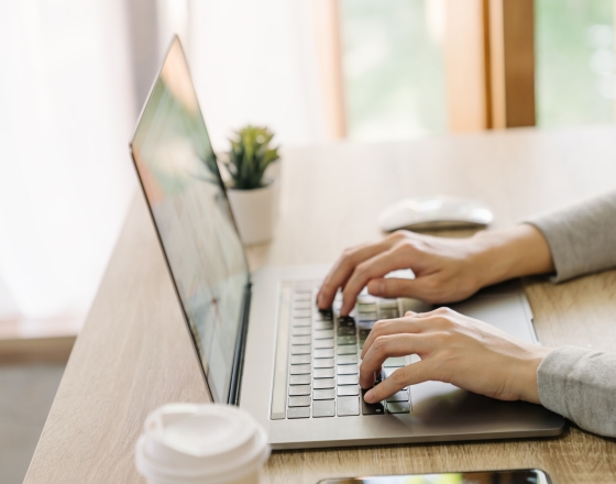 Person typing on a computer. 