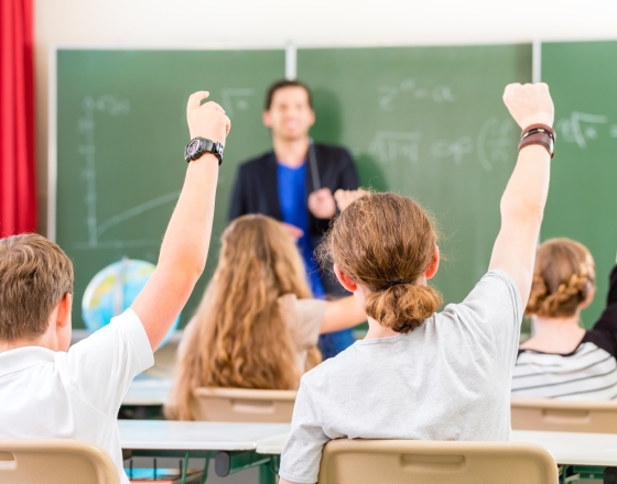 students raising their hands