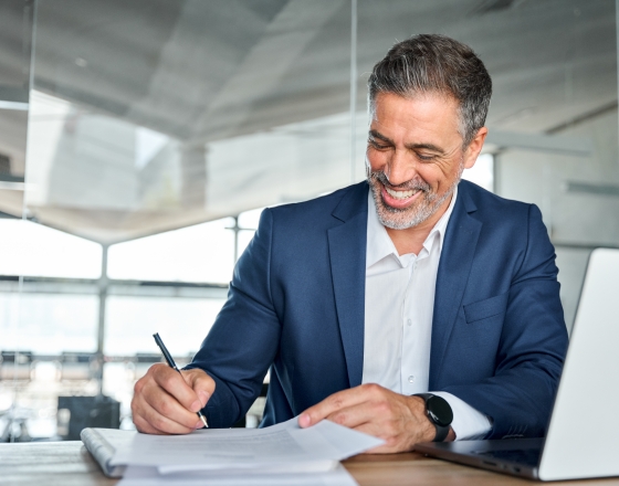 Person writing on paper documents.