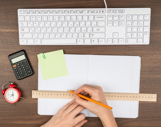 Ruler and paper next to keyboard. 