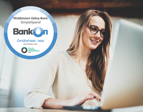 Girl Using Computer With Bank On Approved Seal On Top